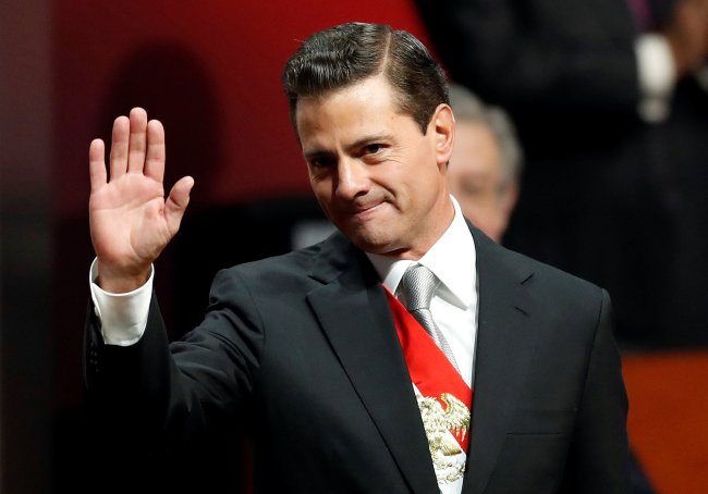 Mexico's President Enrique Pena Nieto waves as he arrives to deliver his sixth and last State of the Union address at the National Palace in Mexico City